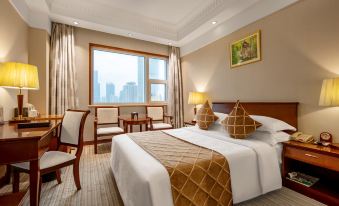 a spacious bedroom with large windows and a double bed in the center at Shanghai Shaanxi Business Hotel