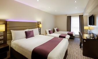 a hotel room with two beds , one on the left and one on the right side of the room at Dublin Airport