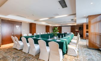 a conference room set up for a meeting , with chairs arranged in a semicircle around a table at Como Hotel