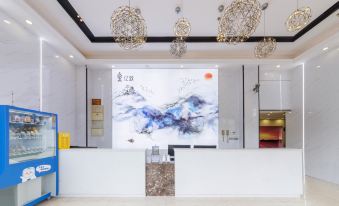 The lobby features a large painting on the wall with an accompanying artwork hanging from it at Yizhi Hotel