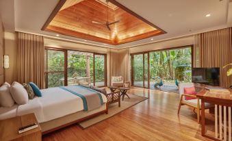a spacious bedroom with a king - sized bed and a view of a swimming pool outside at The Farm at San Benito