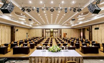 a large conference room with multiple tables and chairs arranged for a meeting or event at Grand Ratchapruek Hotel