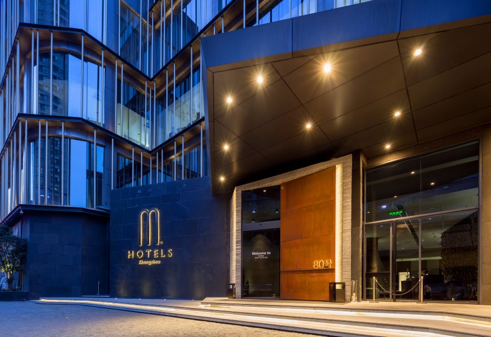 "the entrance of a modern hotel building with the name "" m hotels "" on its facade" at M Hotel