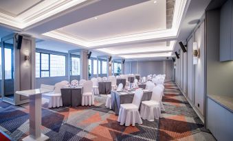 A ballroom is set up with tables and chairs for an event at the hotel or conference at Mercure Guangzhou Beijing Road Pedestrian Street Hotel