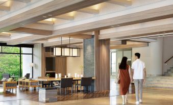a man and a woman are walking through a spacious living room with large windows , hardwood floors , and wooden furniture at Izu Marriott Hotel Shuzenji