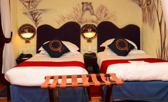 a hotel room with two beds , a wooden nightstand , and a rug on the floor at Amboseli Serena Safari Lodge