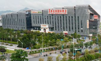 There is a large building with many windows and an office complex in the middle on one side at Vienna International Hotel (Shenzhen North Railway Station)