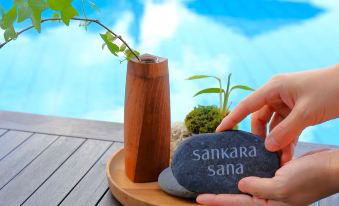 "a person is holding a rock with the word "" sankara sanaa "" written on it" at Sankara Hotel & Spa Yakushima