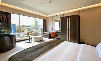 a luxurious hotel room with a large window overlooking the city , a comfortable bed , and modern furniture at Lakeside Hotel