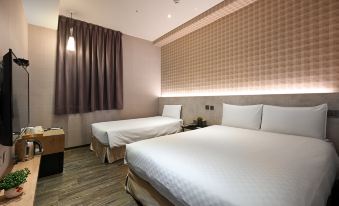 a hotel room with two beds , a nightstand between them and a window with purple curtains at Le Room Hotel Taoyuan