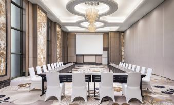 a large conference room with a long table and multiple chairs arranged for a meeting at Sheraton Can Tho