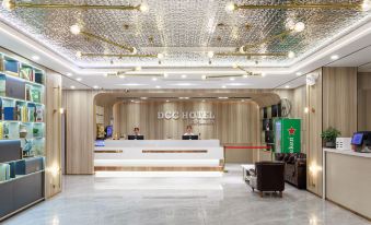The hotel features a lobby and reception area with an illuminated ceiling and wood paneling at DCC Hotel (Guangzhou Tianhe Coach Terminal Station)