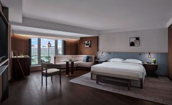 The bedroom features two beds and is connected to a living room with spacious windows on one side at Grand Hyatt Beijing