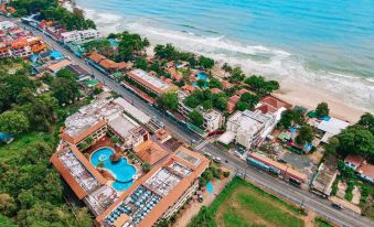 an aerial view of a beachfront resort with buildings , pools , and people on the beach at Kacha Resort & Spa, Koh Chang