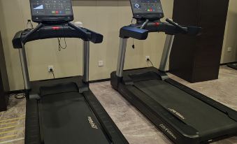 The gym is equipped with a treadmill and an exercise machine for guests to use at UrCove by HYATT Beijing Forbidden City