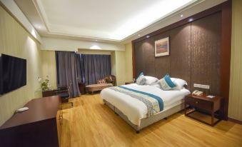 The middle room features a large bed, wood flooring, and a glass shower door that leads to another room at Huachen San Siro Hotel