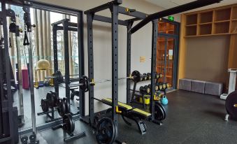 There is a gym located on both the middle and top floors, featuring multiple exercise equipment arranged in close proximity at Qiuguo Hotel (Beijing Sanlitun Gongti Branch)