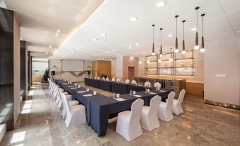 A spacious room is arranged with tables and chairs for hosting events or functions at Jinfan Wanyuan Hotel