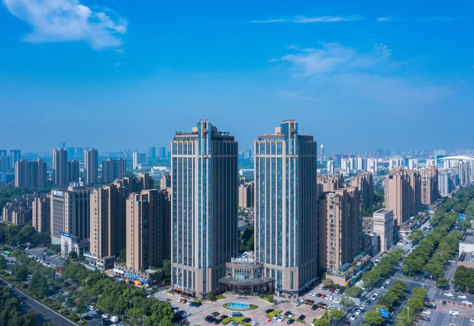 The cityscape features tall buildings and skyscrapers in the foreground, as viewed from a high vantage point at Earl Family Hotel Jiaxing Nanhu