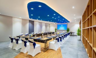 a conference room set up for a meeting , with chairs arranged in rows and a table in the center at TUI BLUE Nha Trang