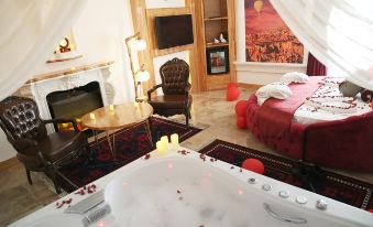 a luxurious bedroom with a large bathtub in the middle of the room , surrounded by furniture and decorations at Emirtimes Hotel&Spa - Tuzla