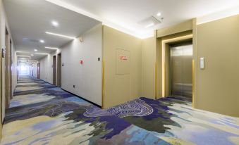 The room is spacious and includes an elevator and carpeted flooring, as well as partitions at Capital Airport International Hotel