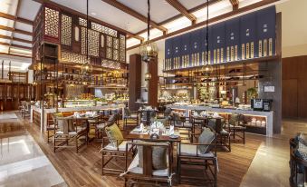 The restaurant is furnished with tables, chairs, and other dining room furniture at Steigenberger Chengdu