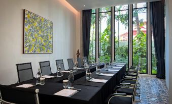A room is available for business meetings or social gatherings, featuring large windows and long tables at Hotel Vellita Siem Reap