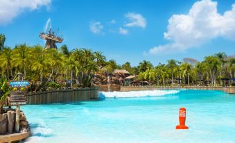 a large body of water with a blue and white orange warning buoy on a shore at Disney's Pop Century Resort - Classic Years