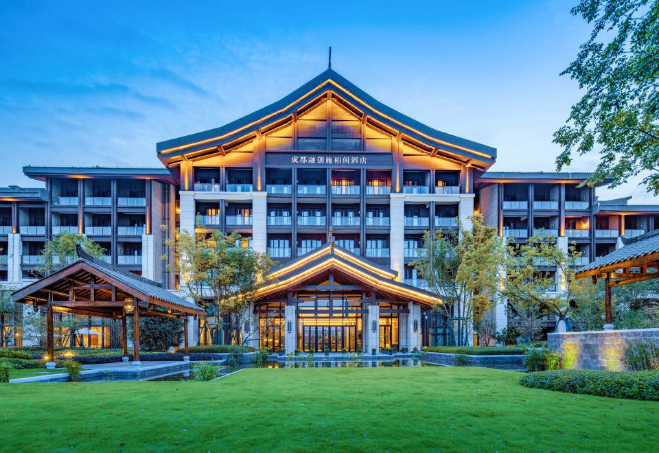 The hotel has a front view featuring a large stone facade and a wood-paneled exterior on both sides at Steigenberger Chengdu