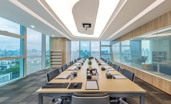 The meeting room features large windows and a long table that can accommodate up to six people at Grade Hotel Shenzhen sea world