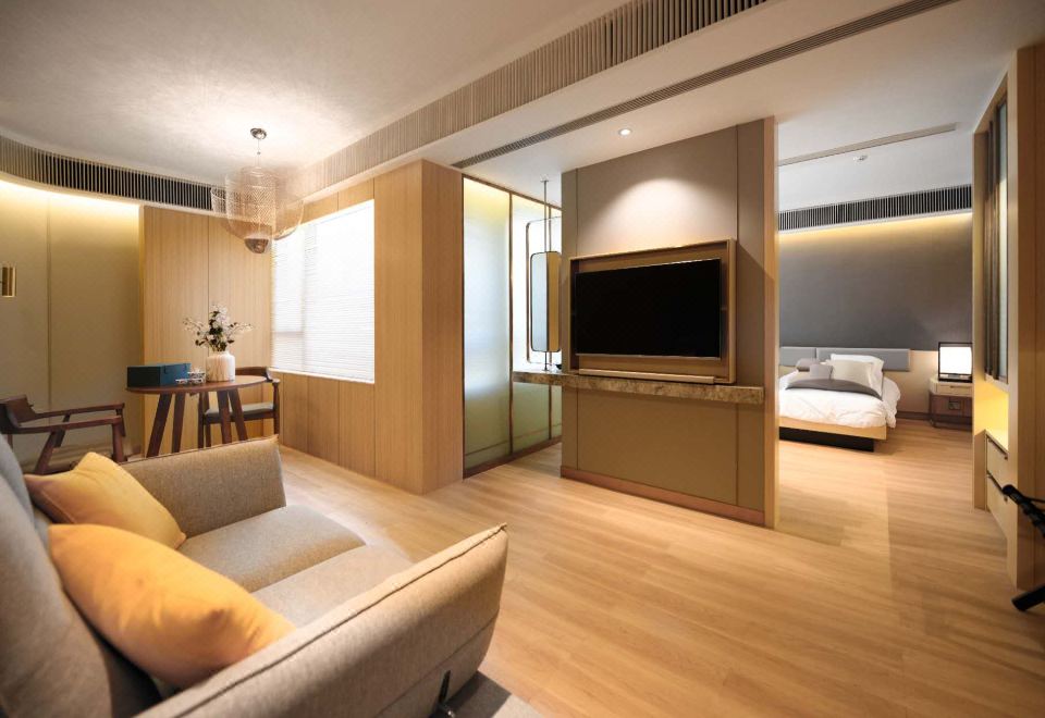 The modern apartment features a spacious living room with a large TV, as well as comfortable beds in the other rooms at The Lotus House