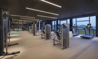 The room is spacious and contains multiple exercise equipment, as well as an indoor gym area at Hyatt Place Hangzhou International Airport