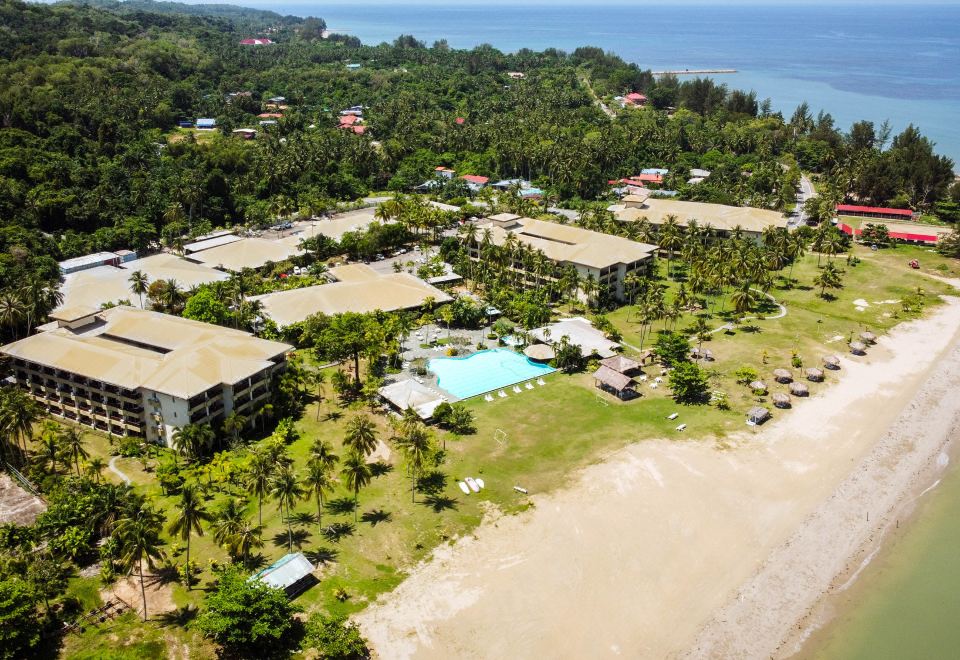 aerial view of a resort on the beach , featuring a large pool surrounded by palm trees at Palm Beach Resort & Spa