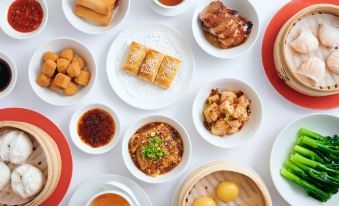 A table is adorned with an assortment of dishes and food, all presented on white plates at Hyatt Regency Hong Kong, Tsim Sha Tsui