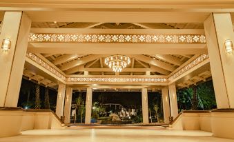 a large hotel lobby with a chandelier hanging from the ceiling and a fountain in the center at Pelangi Beach Resort & Spa, Langkawi