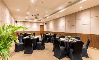 a large conference room with multiple tables and chairs , all set up for a formal event at Outrigger Khao Lak Beach Resort