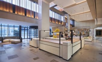 The restaurant is modern, featuring large windows and an atrium that leads to the front counter at Hyatt Place Hangzhou International Airport