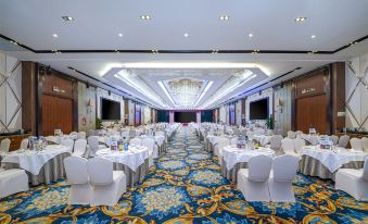 A ballroom is set up with tables and chairs for an event at a hotel or another venue at Gems Cube International Hotel