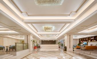 The main room features a large lobby with an ornate ceiling and marble countertops at Vienna International Hotel (Shanghai Pudong Airport)