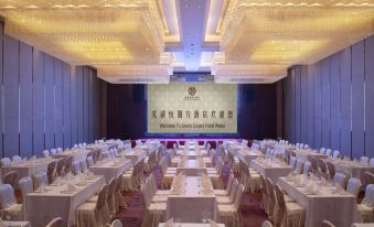 A ballroom is arranged for an event, with tables and chairs placed in the center at Grand Square Hotel Wuhu