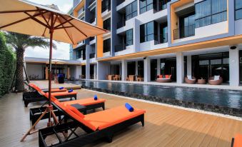 The apartment has a swimming pool with chairs and umbrellas located next to the decking at The Zense Boutique Hotel