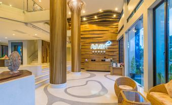 a modern and stylish lobby with wooden columns , a reception desk , and seating areas , all arranged in a spacious space at AVA SEA Resort Krabi