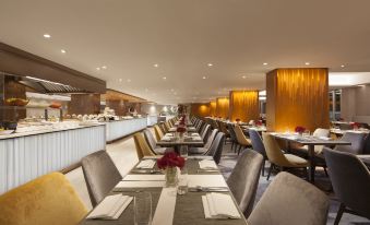 The restaurant features spacious tables and chairs arranged in the center, creating an open concept dining area at Park Hotel Hong Kong