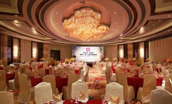 A ballroom is arranged for an event, with tables and chairs placed in the center at Grand Millennium Shanghai HongQiao