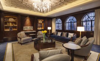elegant and well-appointed living space featuring large windows, a chandelier, and tasteful furniture arranged in the center at Jinjiang Metropolo Hotel Classiq, Shanghai Bund Circle