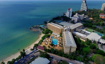 a bird 's eye view of a beachfront hotel with a pool and ocean in the background at Dusit Thani Pattaya