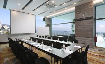 a conference room with a long table , chairs , and water bottles set up for a meeting at Hompton Hotel by The Beach