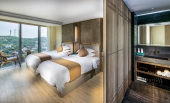 a modern bedroom with two beds , white linens , and wooden furniture , accompanied by a view of the city through large windows at Dongji Island Dongguan Hotel