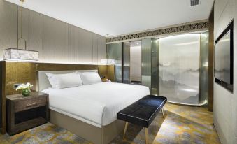 The middle room features a spacious bed, an attached bathroom, and a sitting area adjacent to it at Grand Millennium Shanghai HongQiao
